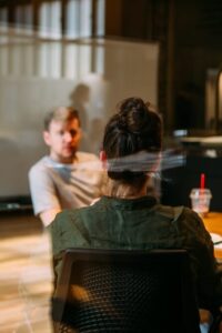 image shows the back of a woman sitting with a man